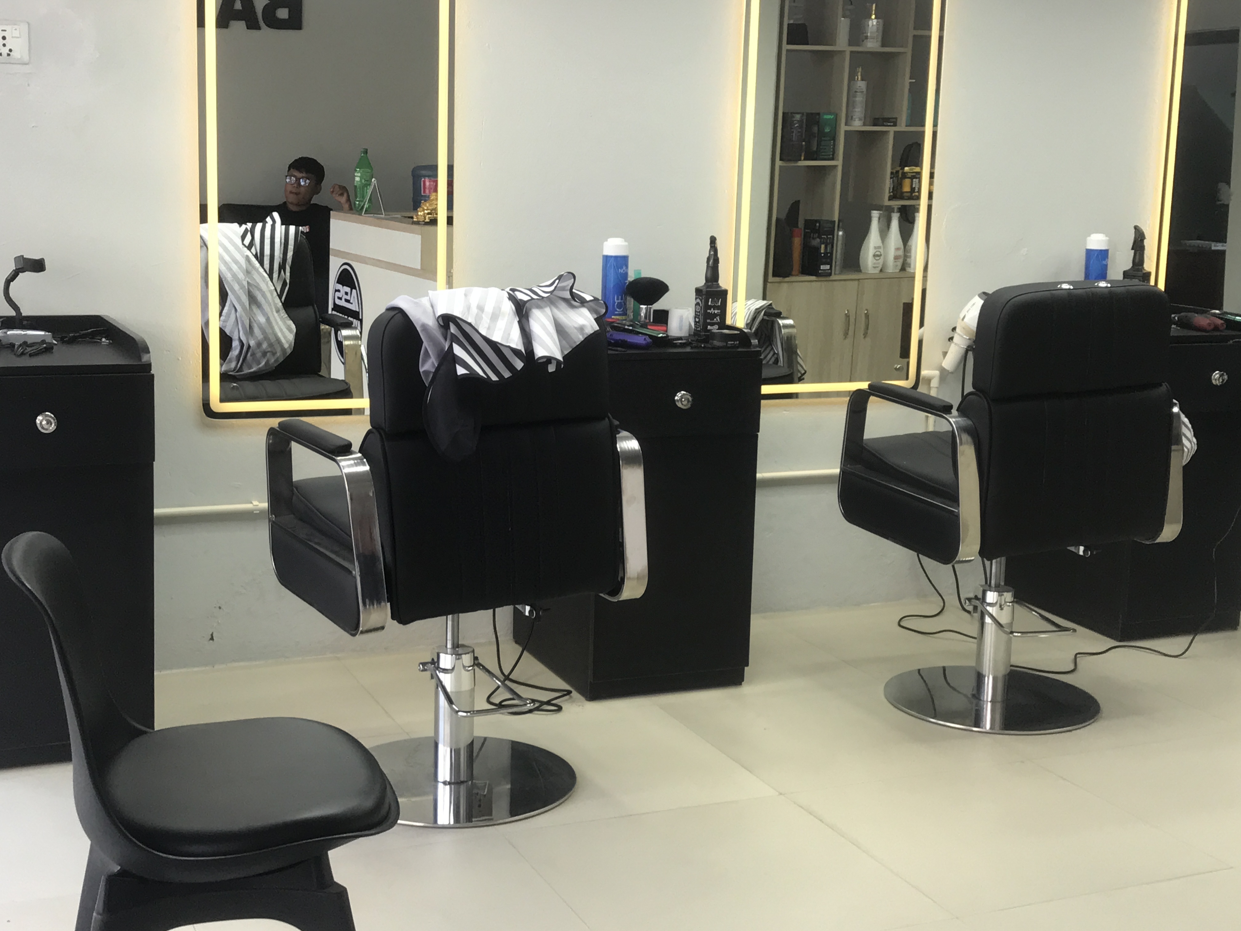 Spacious Ayu's Barber salon floor with barber chairs, mirrors, and clean workstations