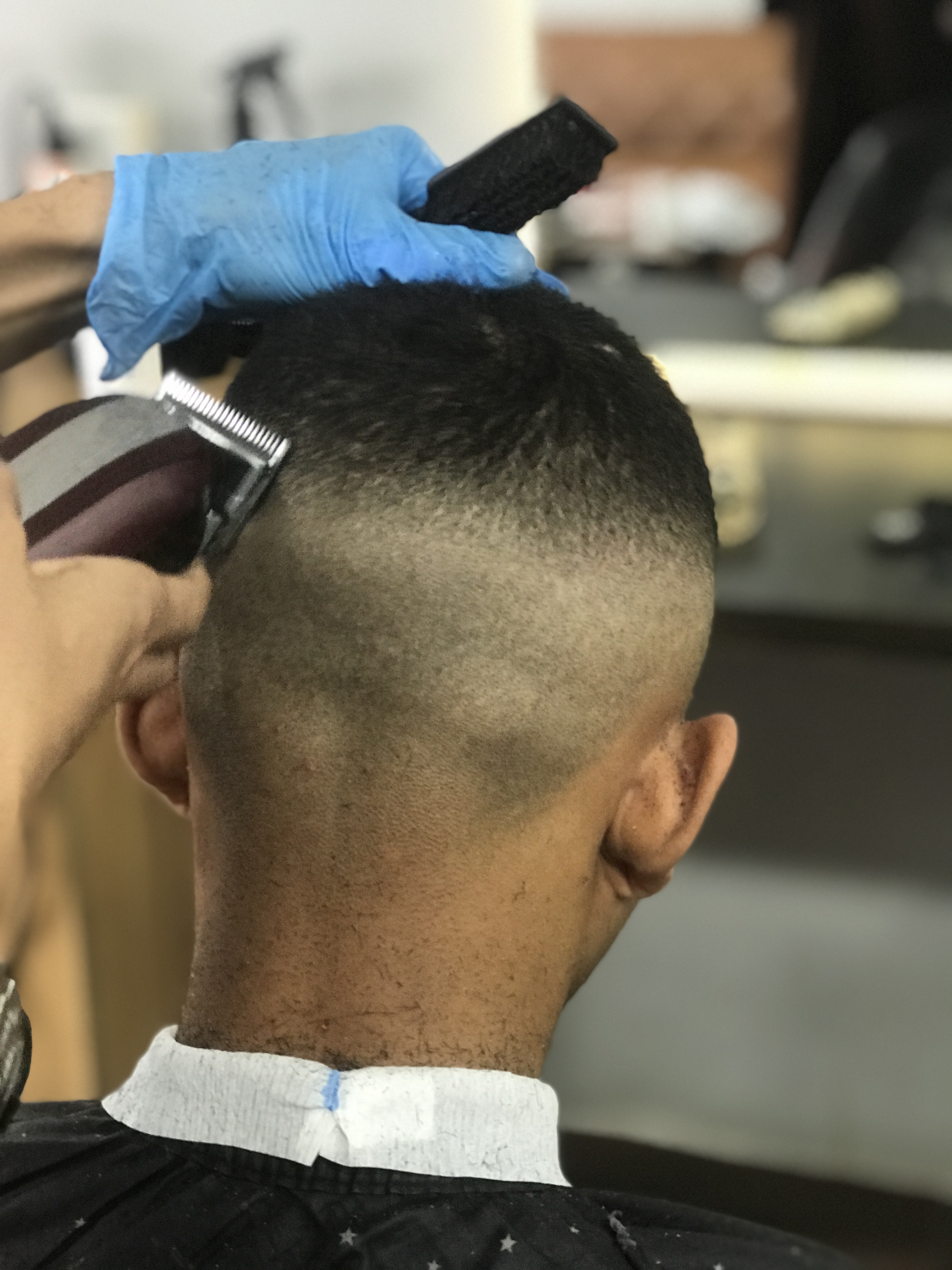 Close back view of clipper work during a fade haircut