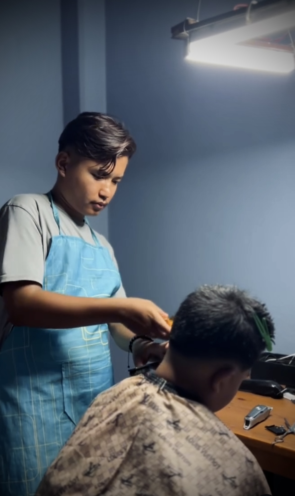 Portrait of Rohit Gurung holding barber clippers