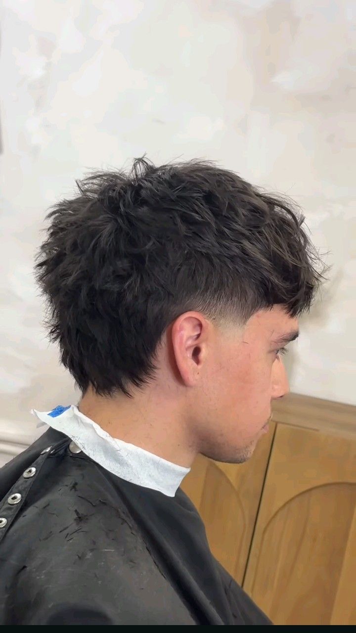 Side view of a taper mullet men's haircut