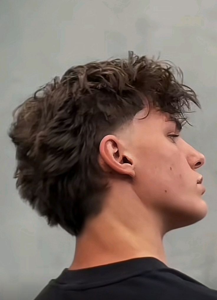 Side view of a modern mullet men's haircut
