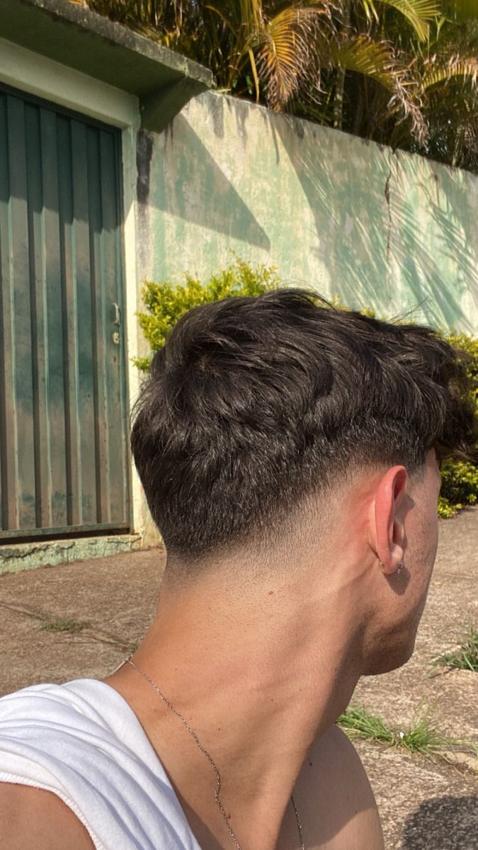 Back view of a natural taper men's haircut