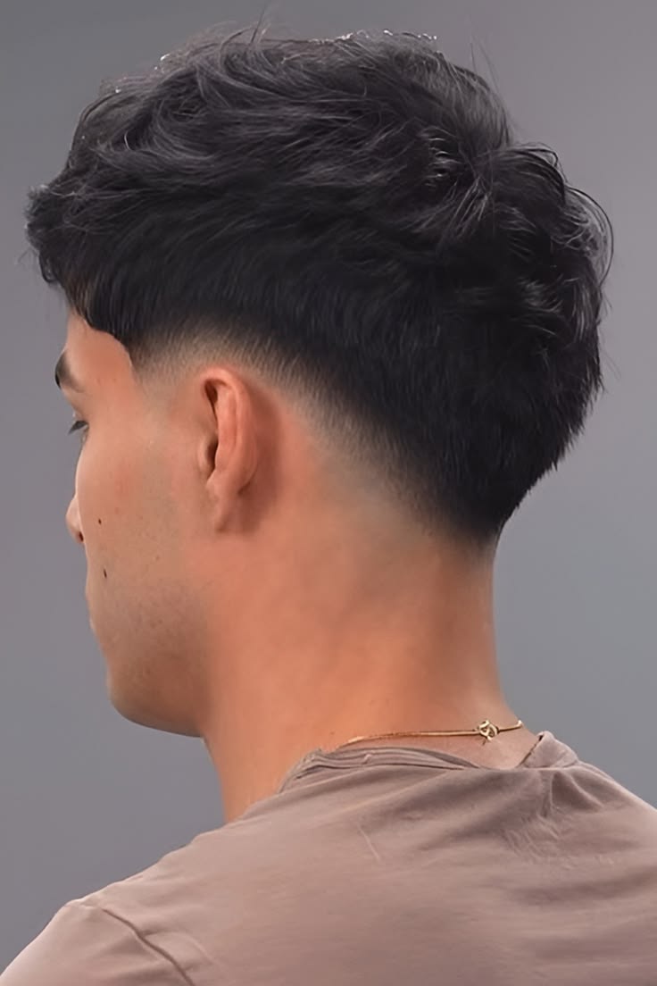 Back side view of a low taper textured men's haircut