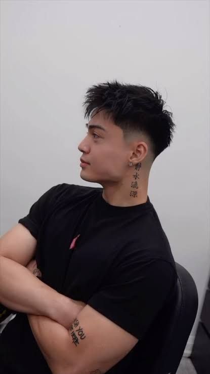 Side portrait of a messy top fade men's haircut