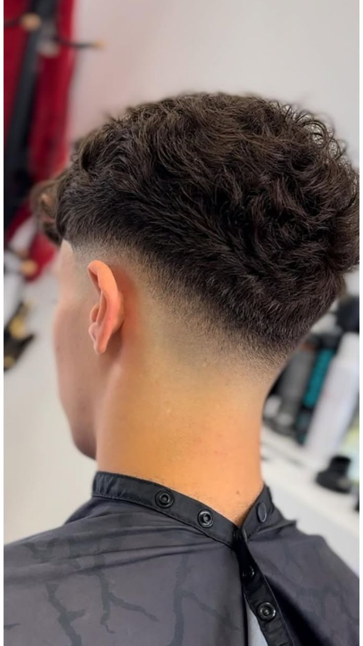 Back view of a curly taper men's haircut