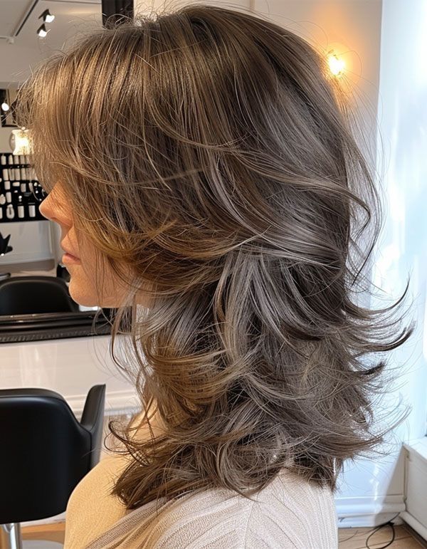Side view of feathered layered women's hairstyle